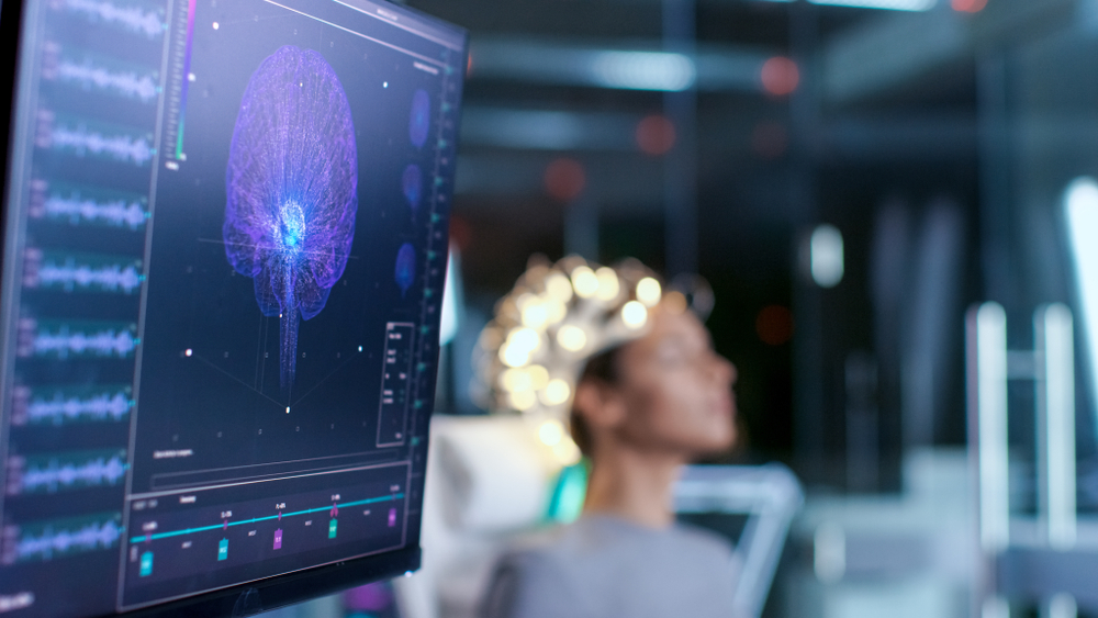 Woman Wearing Brainwave Scanning Headset Sits In A Chair