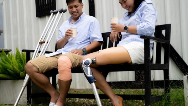 A Couple With Leg Disabilities And Prosthetic Legs Are Walking